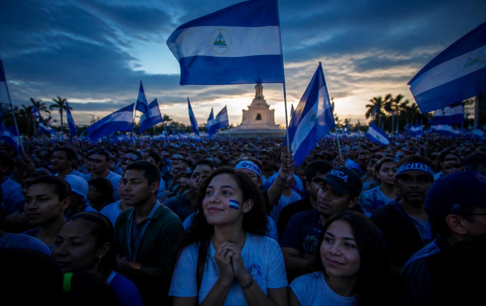 Ciudadanía nicaragüense en una concentración cívica con banderas azul y blanco